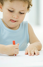 sticking tongue out - concentrating: tongue is at the side of the mouth, also notice the quite crude palmar grasp of the writing/drawing instrument sticking tongue out - concentrating: tongue is at the side of the mouth, also notice the quite crude palmar grasp of the writing/drawing instrument